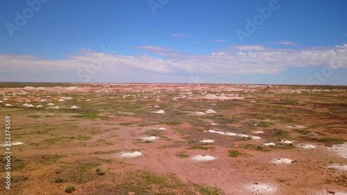 Aerial drone shot of opal mines and mining tailings in the desert outback of Coober Pedy Australia. photo