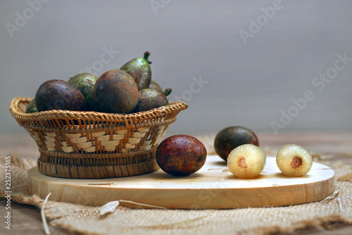 Matoa fruit (pometia pinnata) a typical fruit native from Papua island served on the table. photo