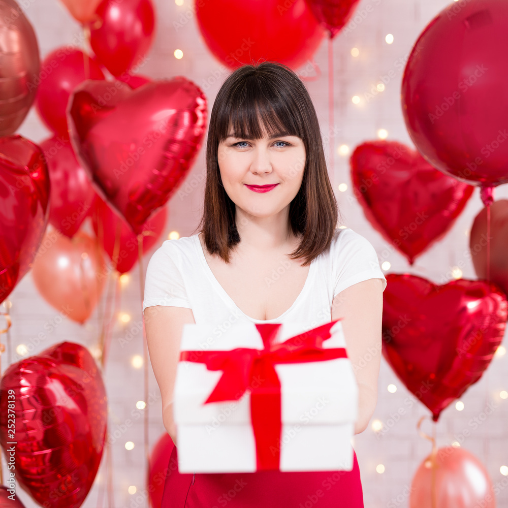 valentine's day concept - portrait of happy beautiful woman with gift box and red balloons valentine's day concept - portrait of happy beautiful woman with gift box and red balloons