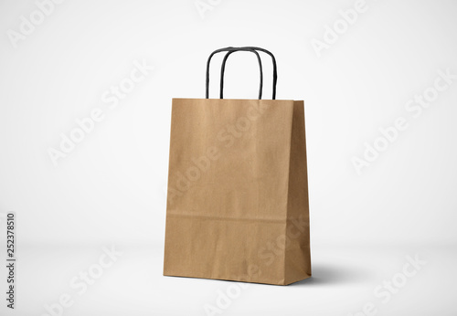 Recycled blank kraft brown paper shopping bag ion soft gray background.Brown paper bag for you design and logo.Mockup.3D illustration