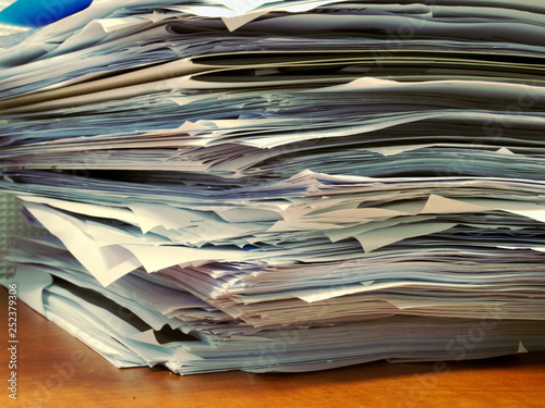 Pile of papers on office desk