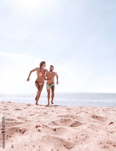 Young couple is fun to spend time on the ocean