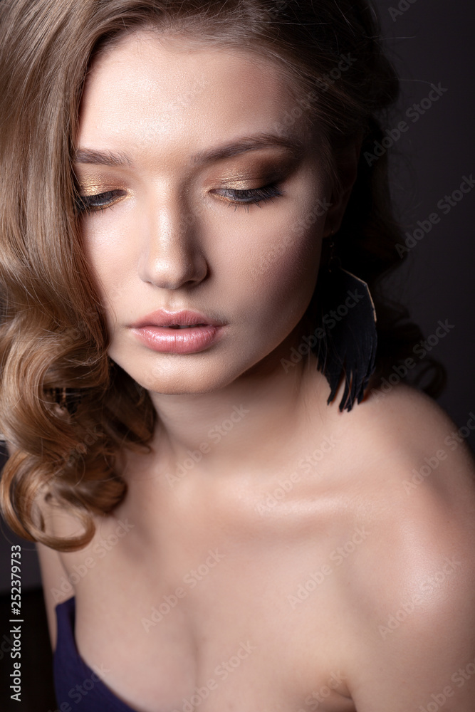 Portrait of a beautiful girl on a gray background. Portrait of a beautiful girl on a gray background.