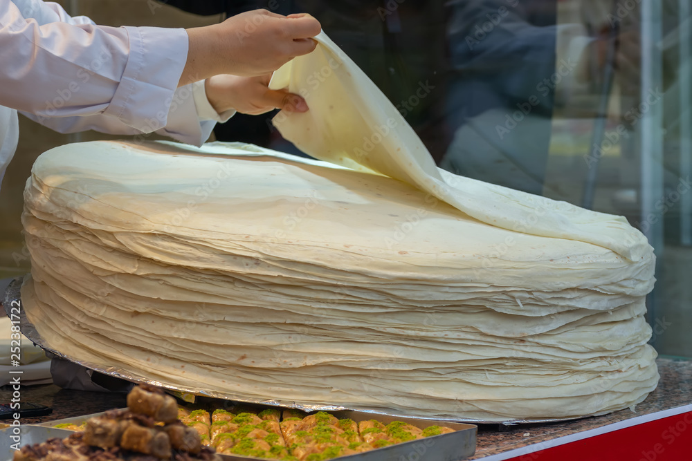 large pile of sheets of dough - Turkish huge circular thin flatbread  sheets, ingredients for making borek and yufka Stock Photo | Adobe Stock