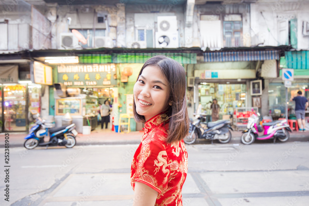 Portrait of beautiful asian girl in red chinese drees up in China town