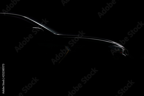 Four-door sport coupe. Silhouette of black sports car with headlights