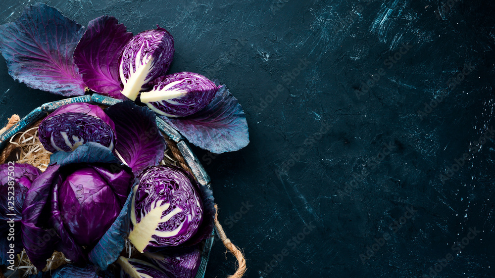 Fresh cabbage. Purple cabbage on a black background. Organic food. Top view. Free space for your text. - obrazy, fototapety, plakaty 