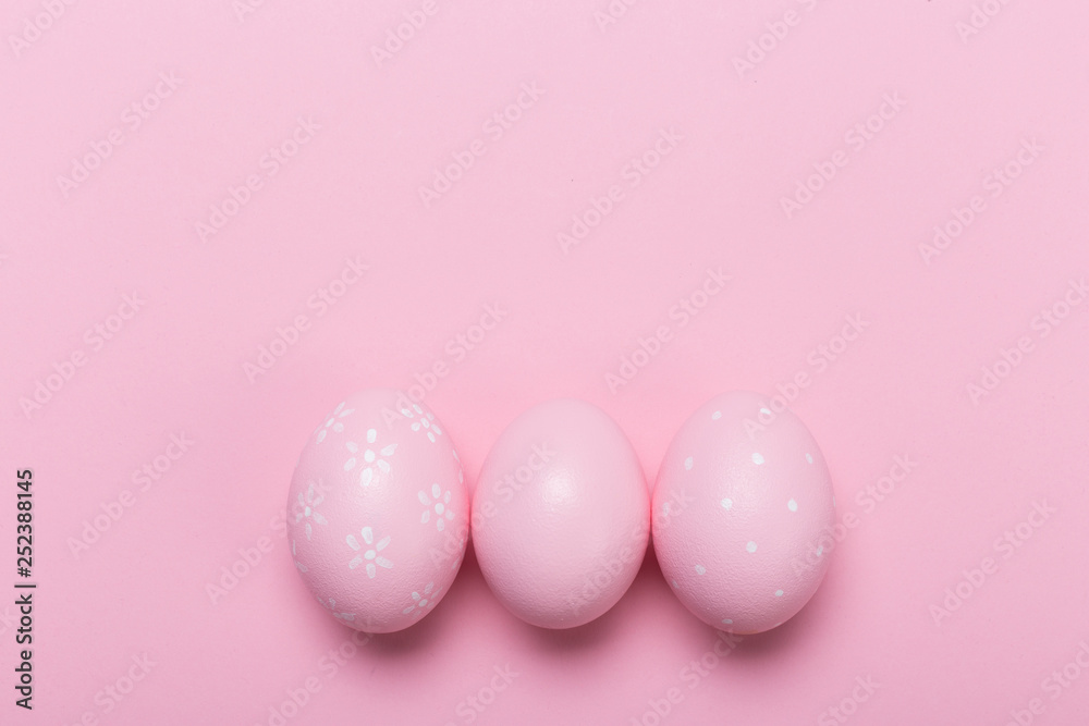 Pink easter eggs in nest on pastel color background with space. Concept