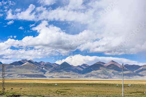 View of grass filed on east side of the  Nyenchen Tanglha Mountains range in Damxung(Dangxiaong) County, Lhasa, Tibet, China. photo