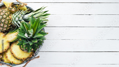 Pineapple in a wooden box. Tropical Fruits. Top view. Free copy space.