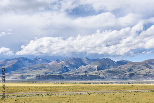 View of grass filed on the east side of the Nyenchen Tanglha Mountains range in Damxung(Dangxiaong) County, Lhasa, Tibet, China. photo