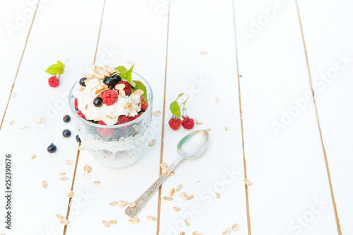 Dessert layered pudding with raspberry and black currant in glass photo