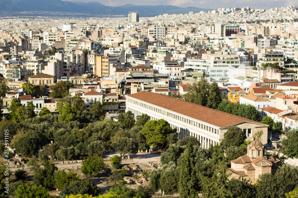 Athens city street with many white buildings and antique ancient temple aerial photography 