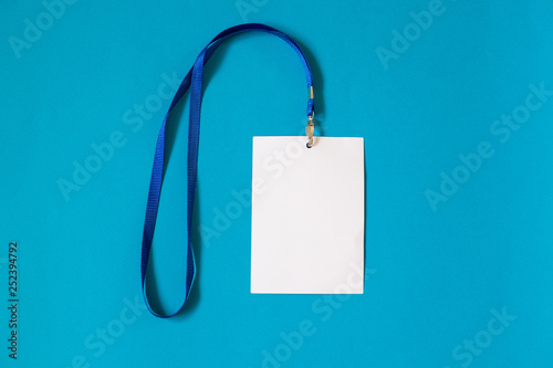 Empty ID card badge icon with blue belt, on blue background. Space for text,  staff identity name tag template.