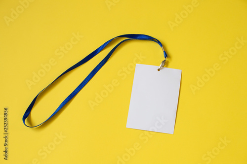 Empty ID card badge icon with blue belt, on yellow background. Space for text,  staff identity name tag template.