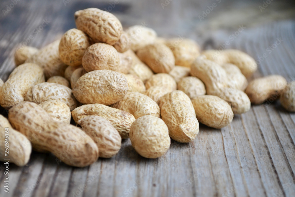 Peanuts in shells on a wooden table Peanuts in shells on a wooden table