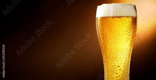 Cold beer and brown background with shadow 