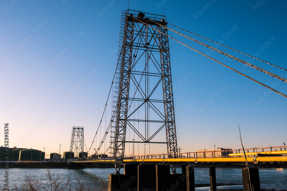 Oilfield pipeline bridge in sunset background Oilfield pipeline bridge in sunset background