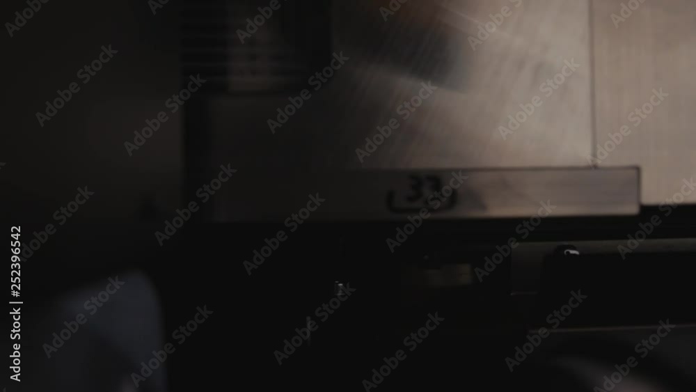 Professional printing facility, big vinyl rolls, ready for large printer supply. Glossy, matte, ecological paper tubes. Detail of massive printhead passing by with purple flashes. Professional printing facility, big vinyl rolls, ready for large printer supply. Glossy, matte, ecological paper tubes. Detail of massive printhead passing by with purple flashes.