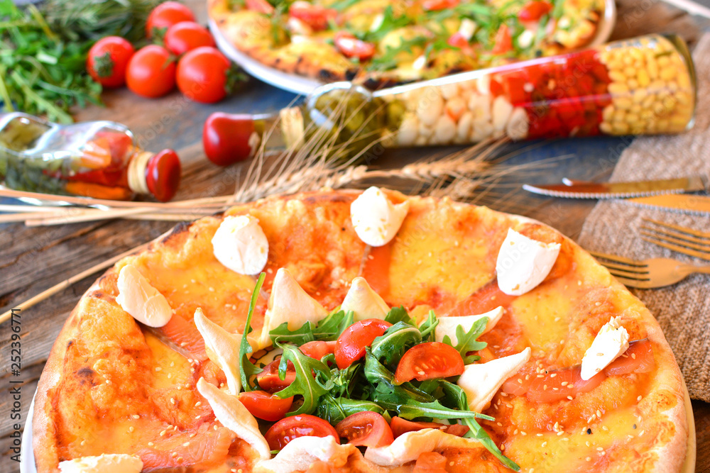 Italian pizza on a rustic cuisine with different ingredients