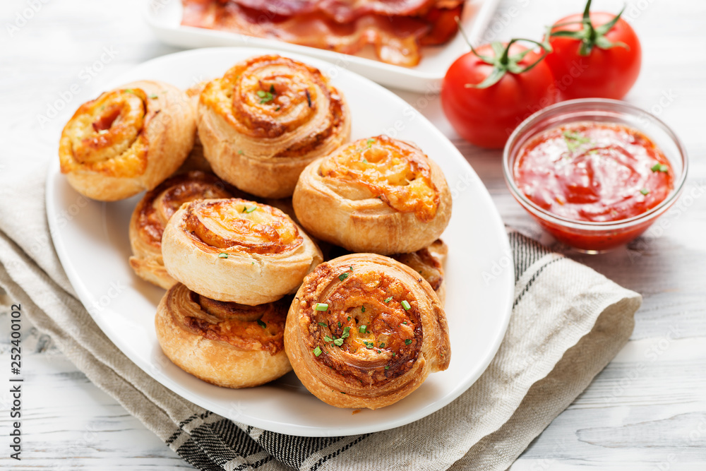 Rolls of puff pastry with bacon and cheese . Rolls of puff pastry with bacon and cheese .