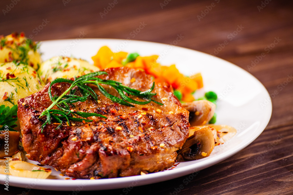 Grilled steak with potatoes and vegetable salad Grilled steak with potatoes and vegetable salad