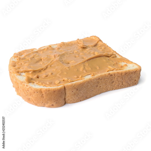 Fresh whole wheat bread slice with chunky peanut butter isolated on a white background.