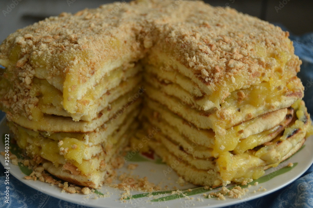 homemade cake withyellow custard. uneven cake with crumbs on top on the blue background homemade cake withyellow custard. uneven cake with crumbs on top on the blue background