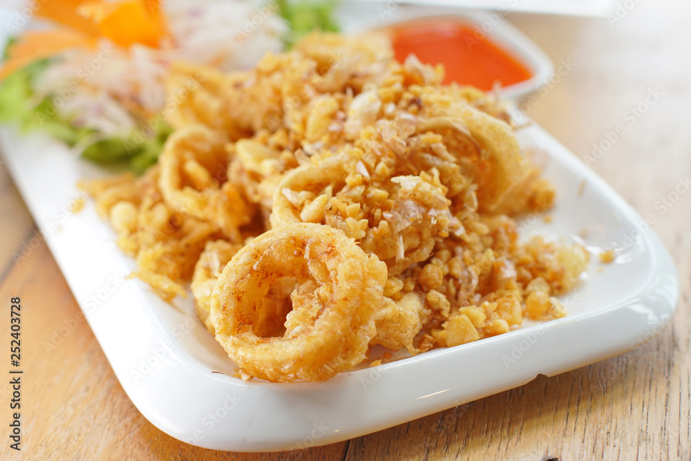 Crispy fried squid dish. Seafood dish in restaurant. Selective focus. Still life shoot in studio, Clean food good taste idea concept. Crispy fried squid dish. Seafood dish in restaurant. Selective focus. Still life shoot in studio, Clean food good taste idea concept.