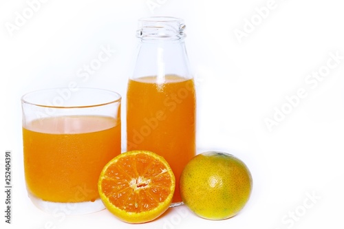 Fototapeta Naklejka Na Ścianę i Meble -  The Orange juice bottle with orange juice glass and orange, half fresh oranges isolated on white background
