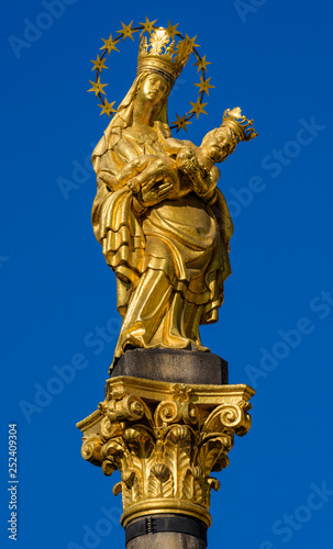 a golden statue of Madonna with a baby, Plague Column, Pilsen, Czech Republic
