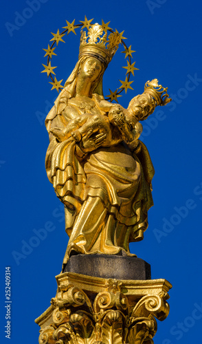 a golden statue of Madonna with a baby  Plague Column  Pilsen  Czech Republic
