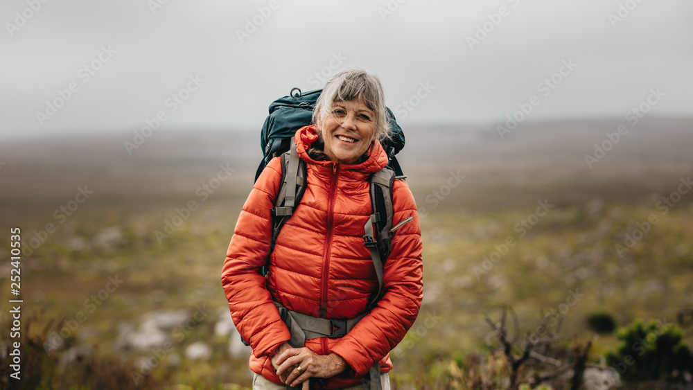 Female hiker standing on a hill