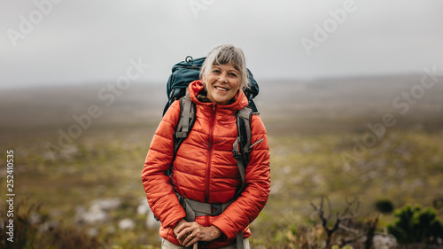 Female hiker standing on a hill