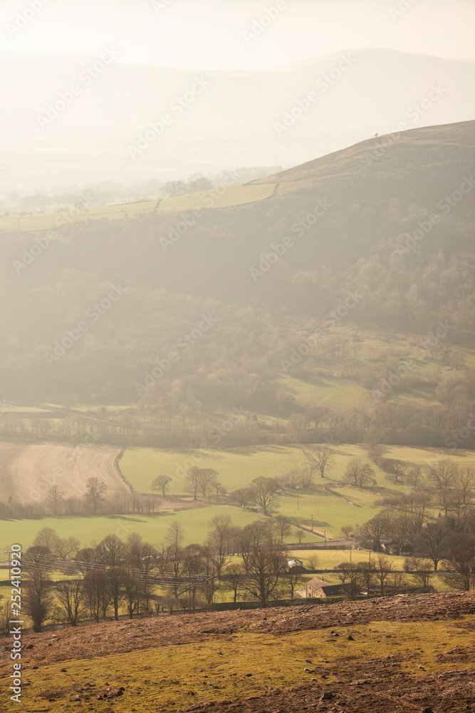 Lovely landscape image of the Peak District in England on a hazy Winter day viewed from the lower slopes of Bamford Edge