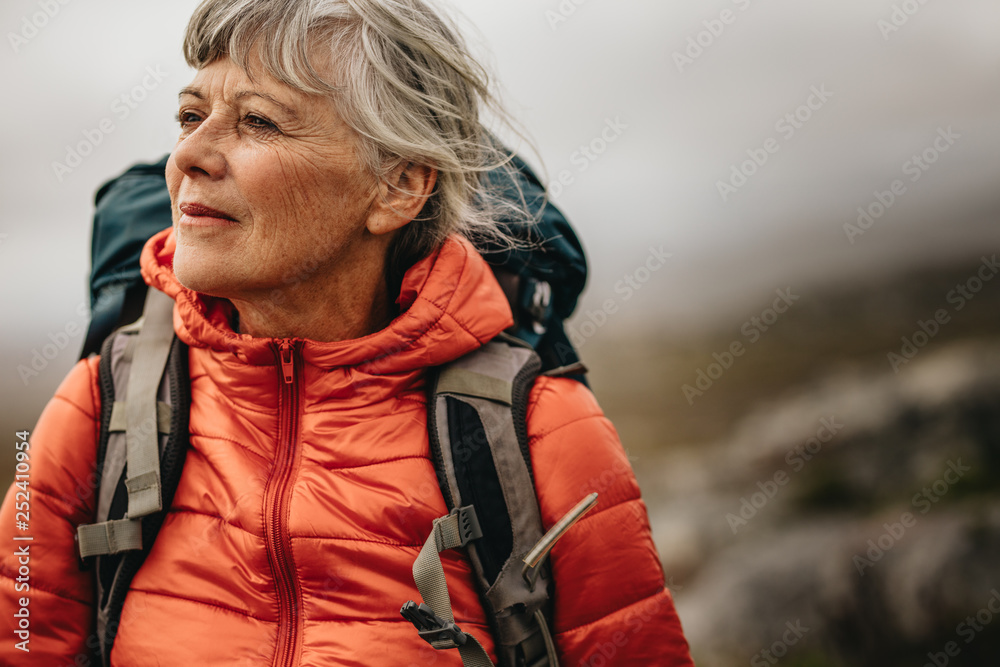 Senior woman on a hiking trip - obrazy, fototapety, plakaty 