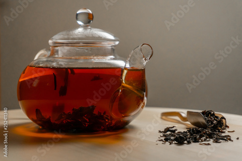 Black brewed tea in teapot on the table