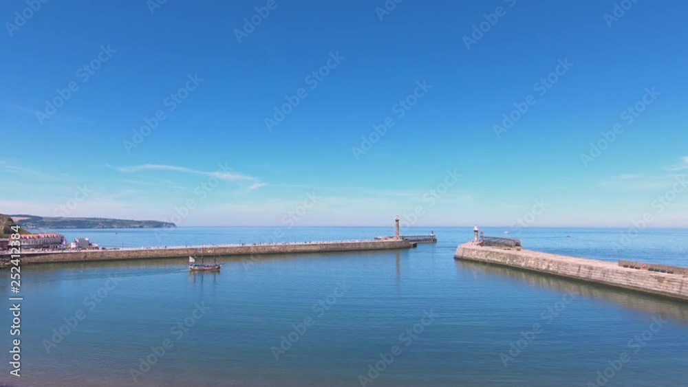 The view across the North Yorkshire port of Whitby in northern England as a tourist pleasure boat departs. The view across the North Yorkshire port of Whitby in northern England as a tourist pleasure boat departs.