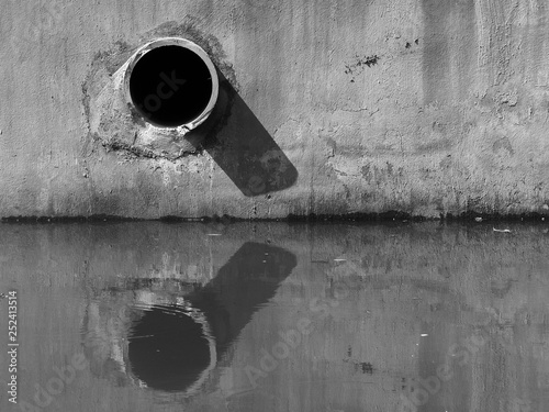 black and white drain water - allow to drain into the canal photo