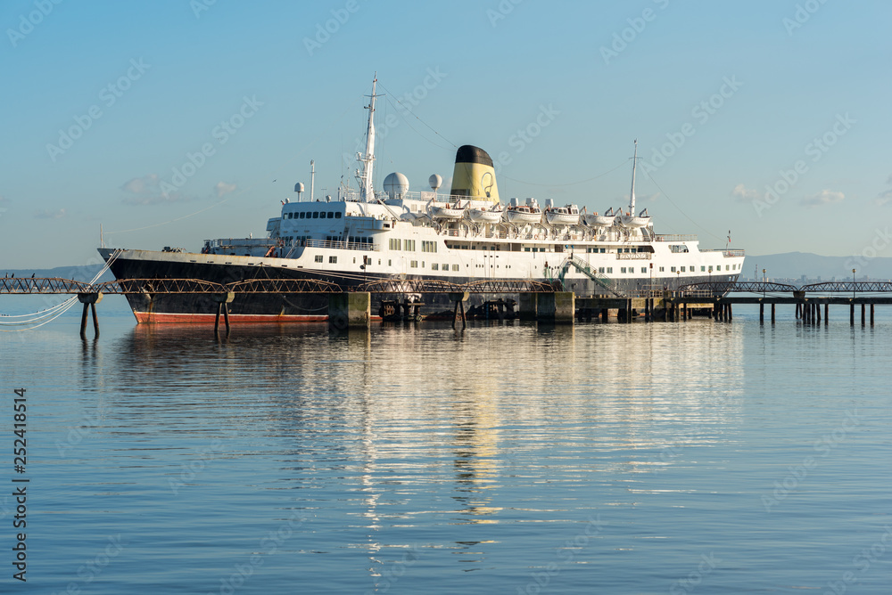 Old cruise ship in the north of Lisbon moored at the jetty on the Tagus river