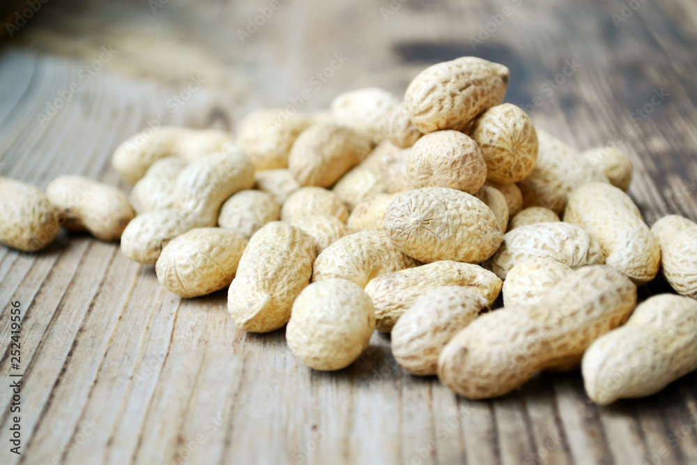 Peanuts in shells on a wooden table Peanuts in shells on a wooden table
