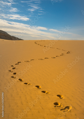 Texture background   footprints of human feet on the desert sand