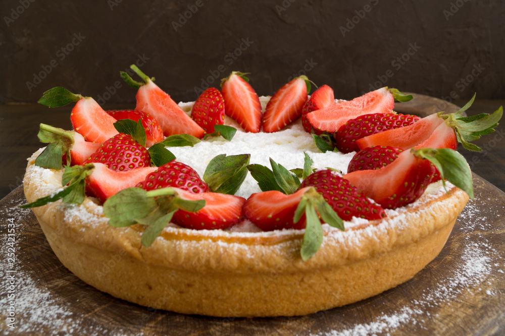 cheesecake with strawberries on a wooden Board. cheesecake with strawberries on a wooden Board.