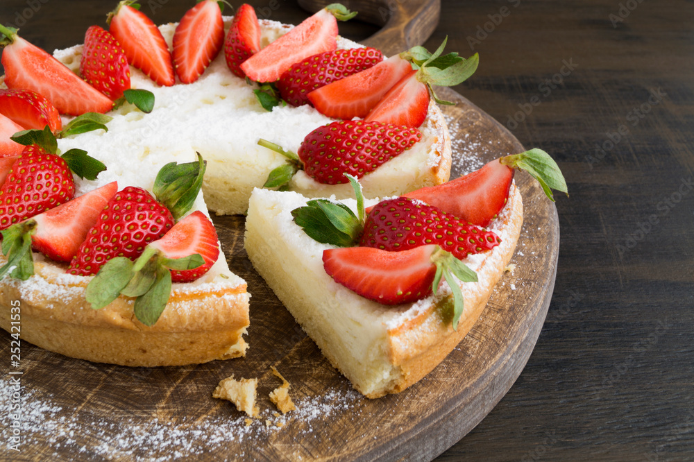 cheesecake with strawberries on a wooden Board. cheesecake with strawberries on a wooden Board.