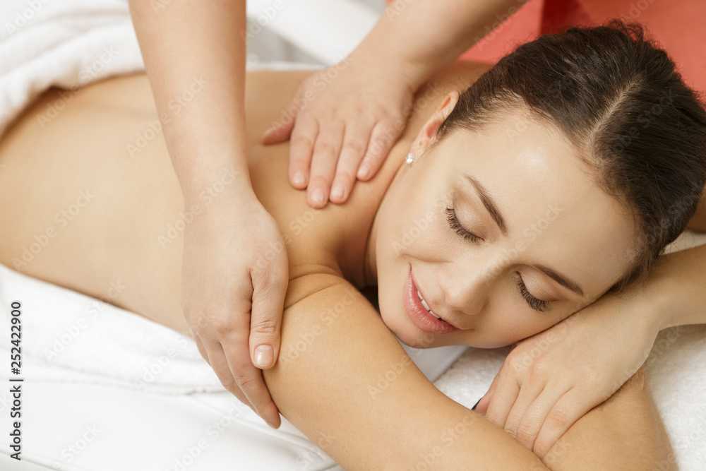 Beautiful female client enjoying full body massage at the spa salon Beautiful female client enjoying full body massage at the spa salon