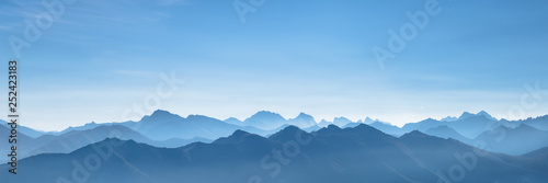 Panorama of the mountains at sunrise in a blue morning haze