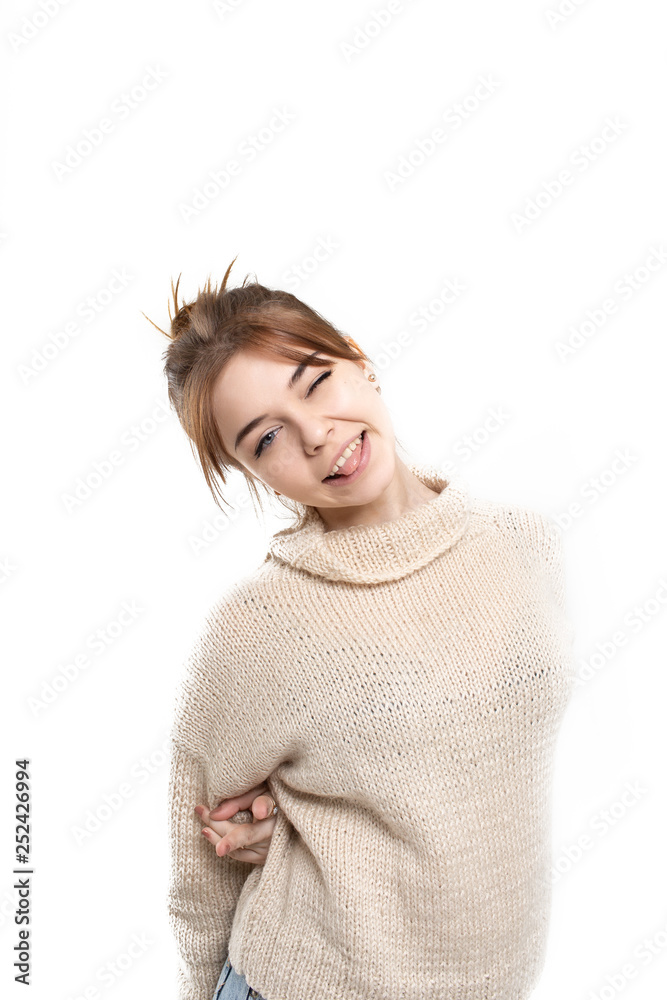 Funny brunette happy girl in beige sweater on white background Funny brunette happy girl in beige sweater on white background