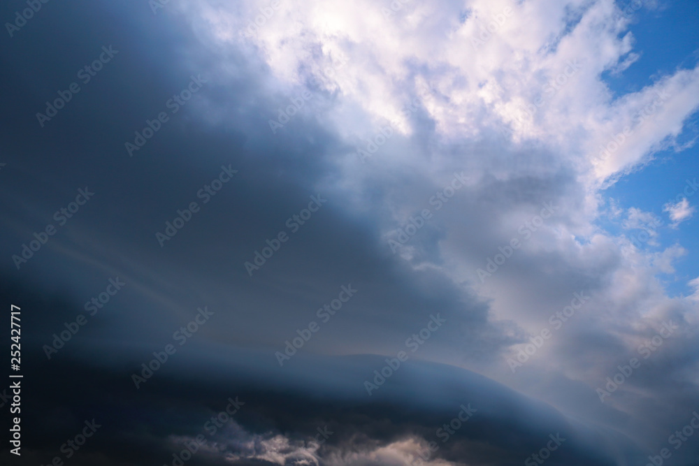 Scary epic sky with menacing clouds. Hurricane wind with a thunderstorm. Stock background, photo