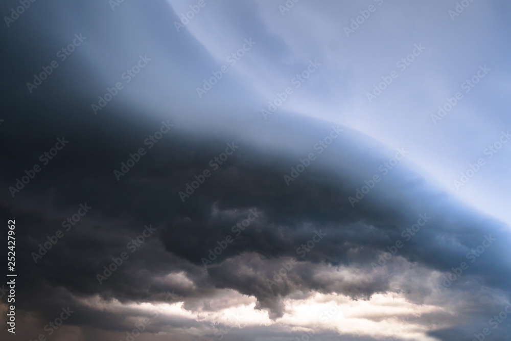 Obraz premium Scary epic sky with menacing clouds. Hurricane wind with a thunderstorm. Stock background, photo