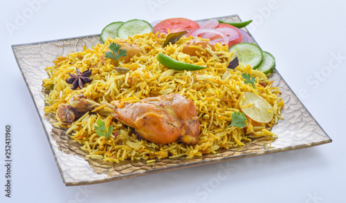 Chicken Biryani, a yummy & fluffy rice dish with spicy savory chicken pieces with salad. photo